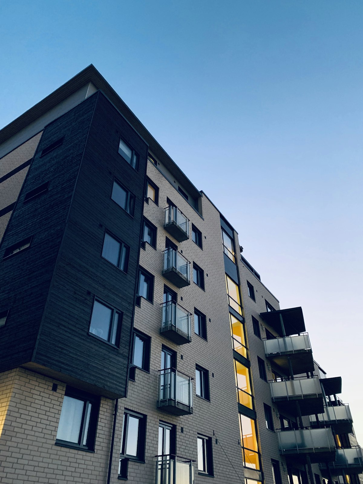Mid-rise apartment building with glass balconies
